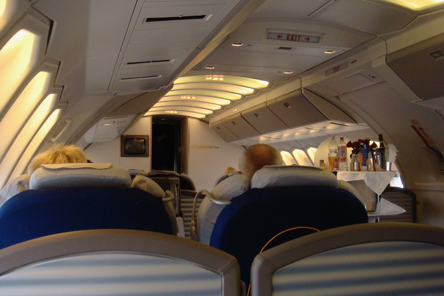 an airplane with seats and a table with drinks