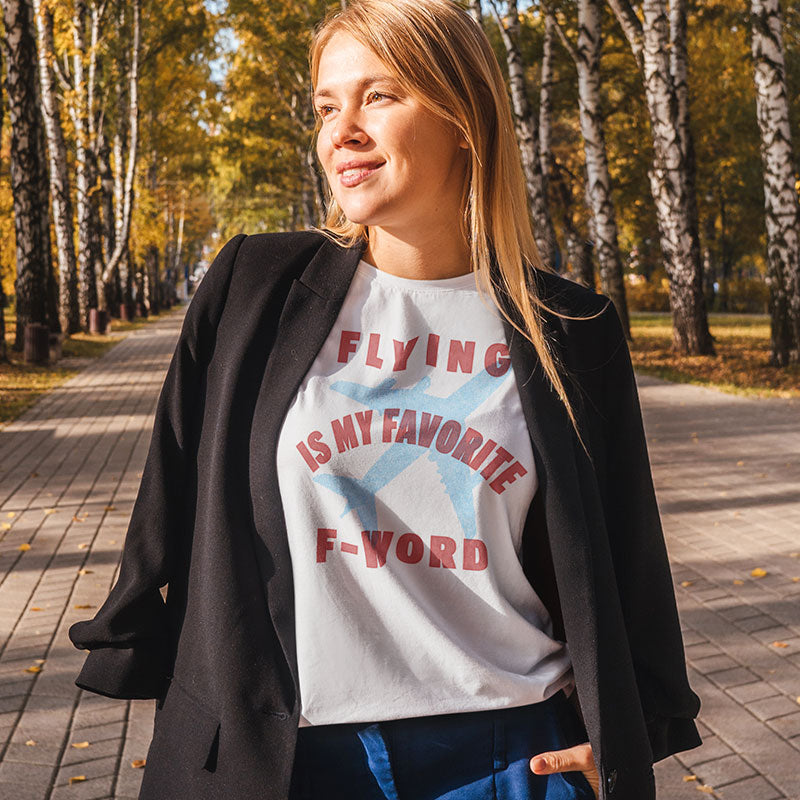 a woman standing on a path with trees in the background