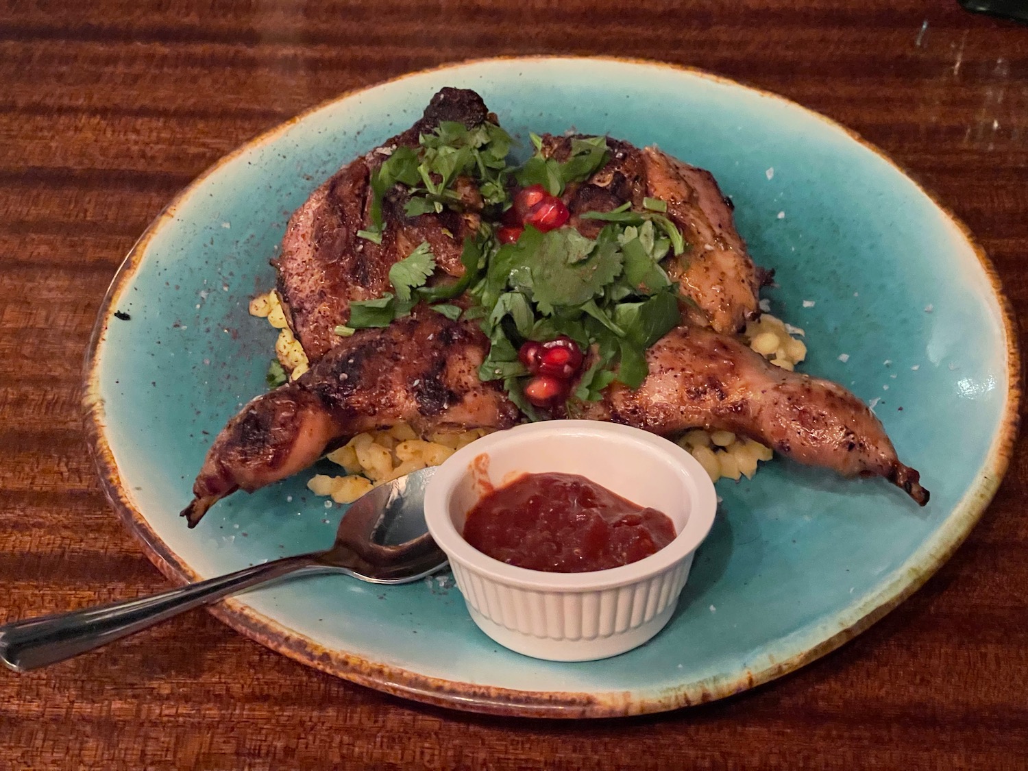 a plate of food with a spoon and sauce