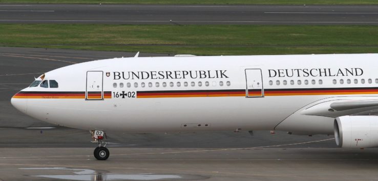 a white airplane on a runway