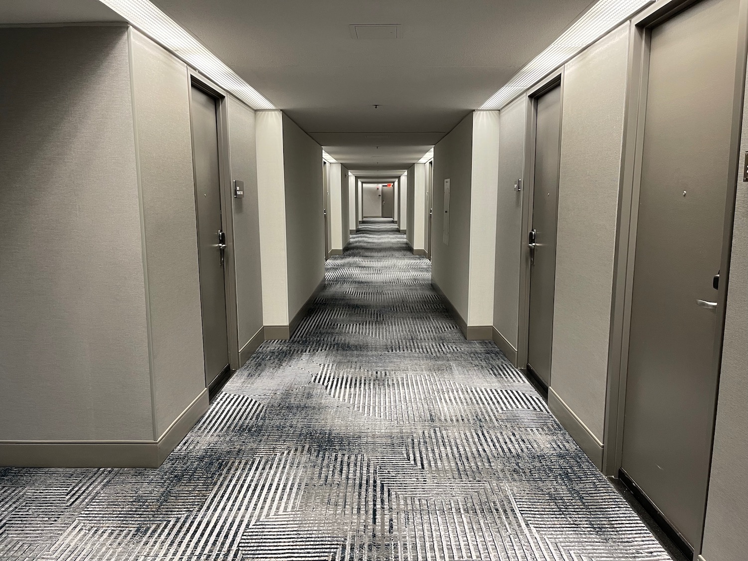 a hallway with doors and carpet