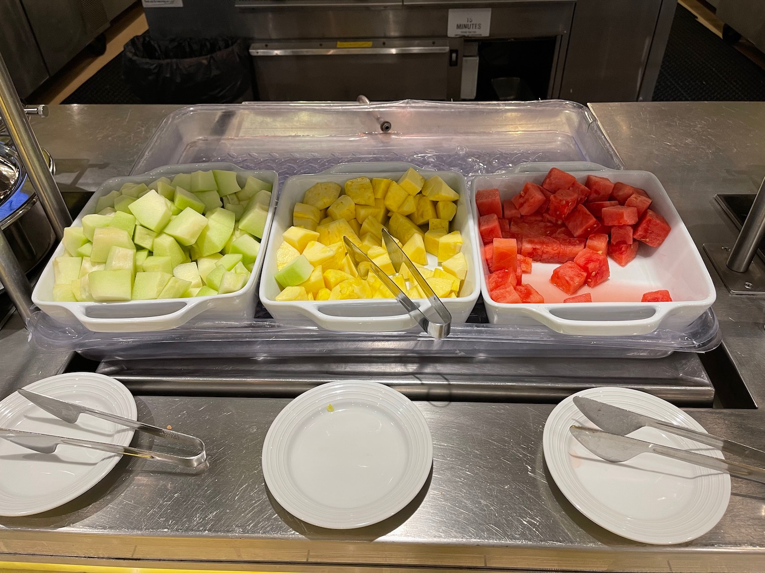 a trays of fruit in a buffet