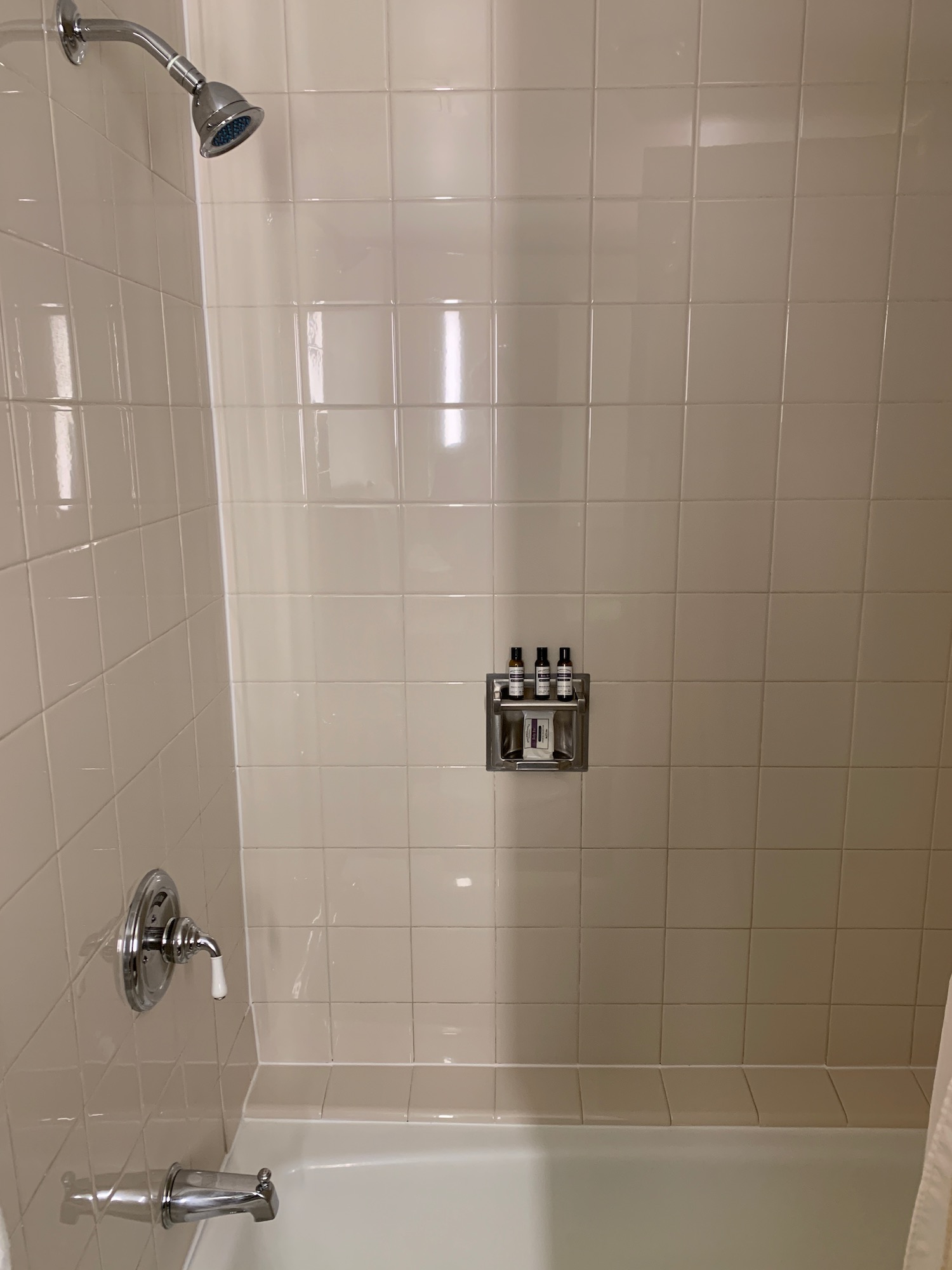 a shower with a shower head and a shower head