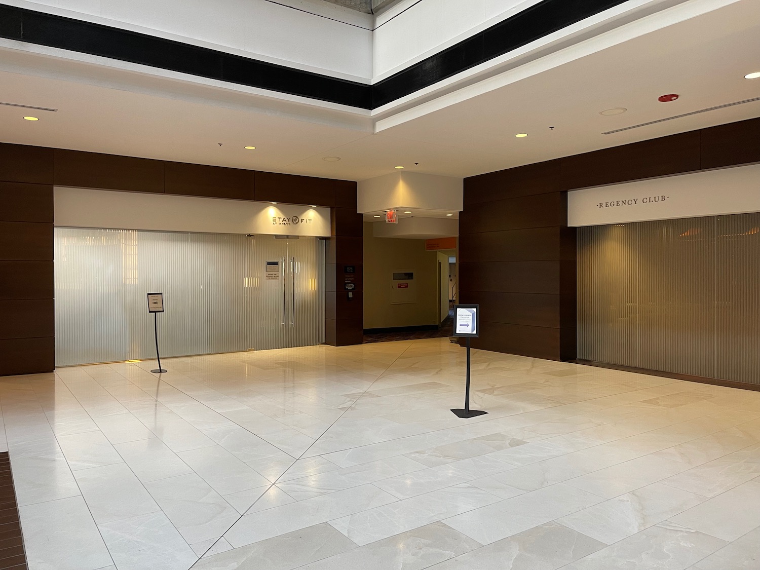 a large building with a sign in front of doors