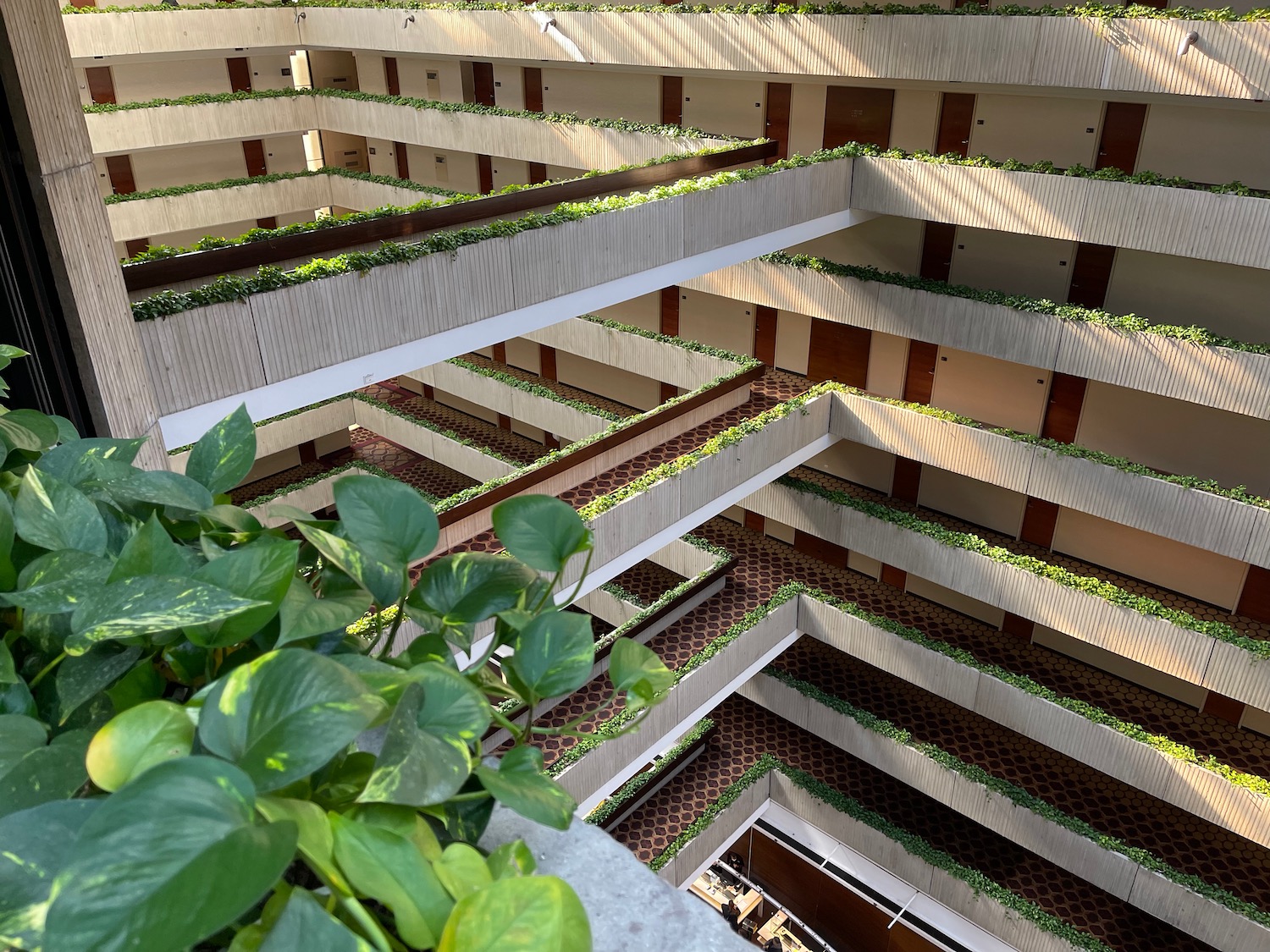 a building with many balconies and plants