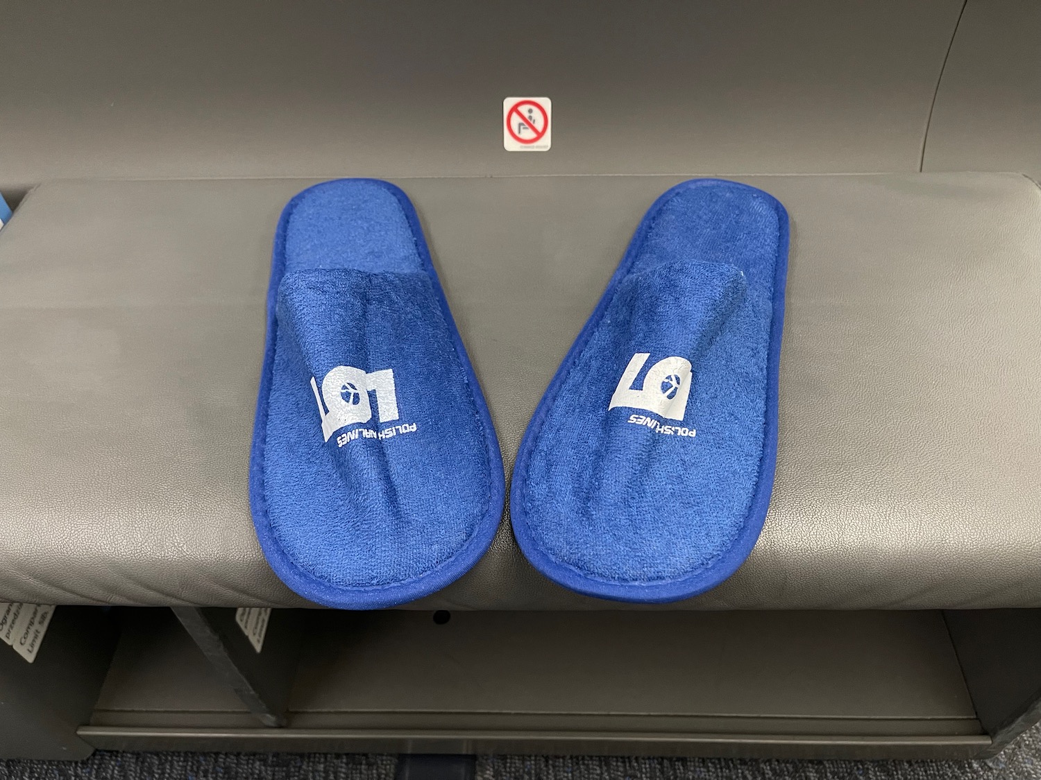 a pair of blue slippers on a grey bench