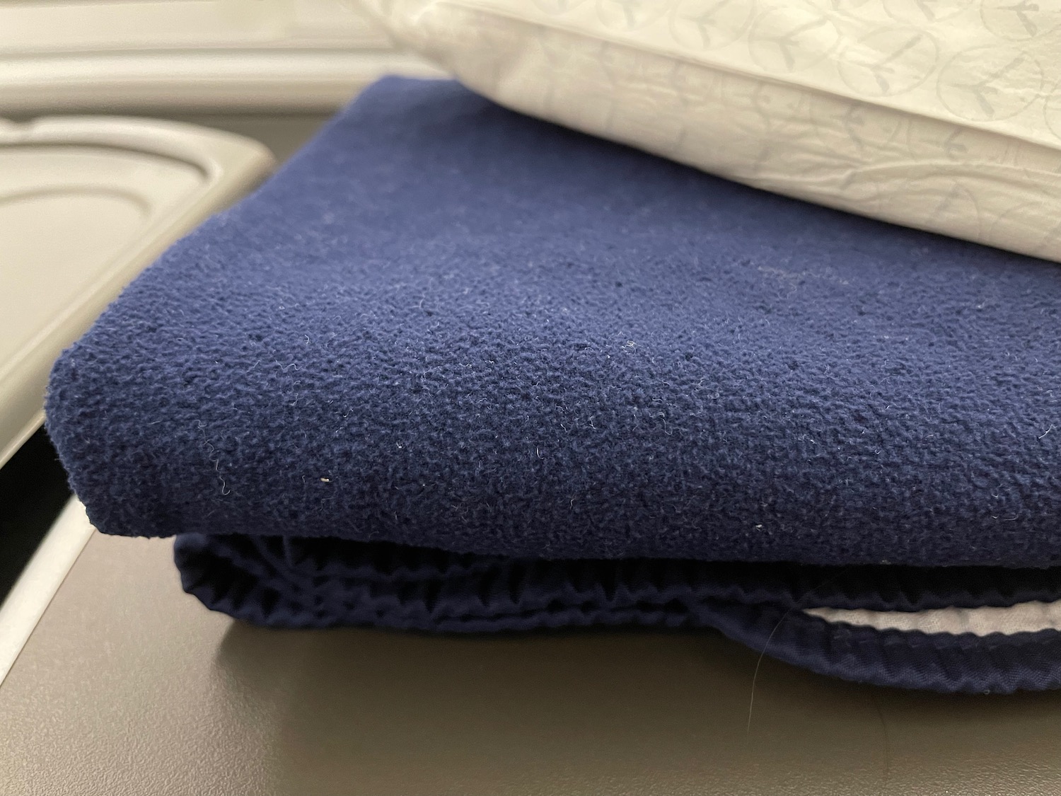 a blue blanket and pillow on a table