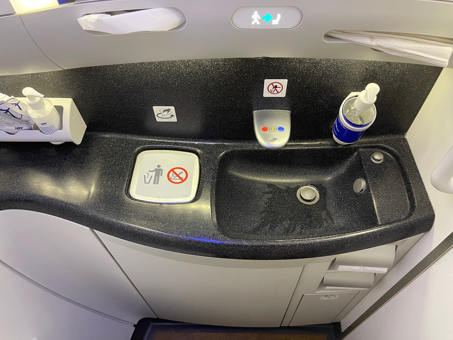 a sink with a bottle and a bottle of liquid on it