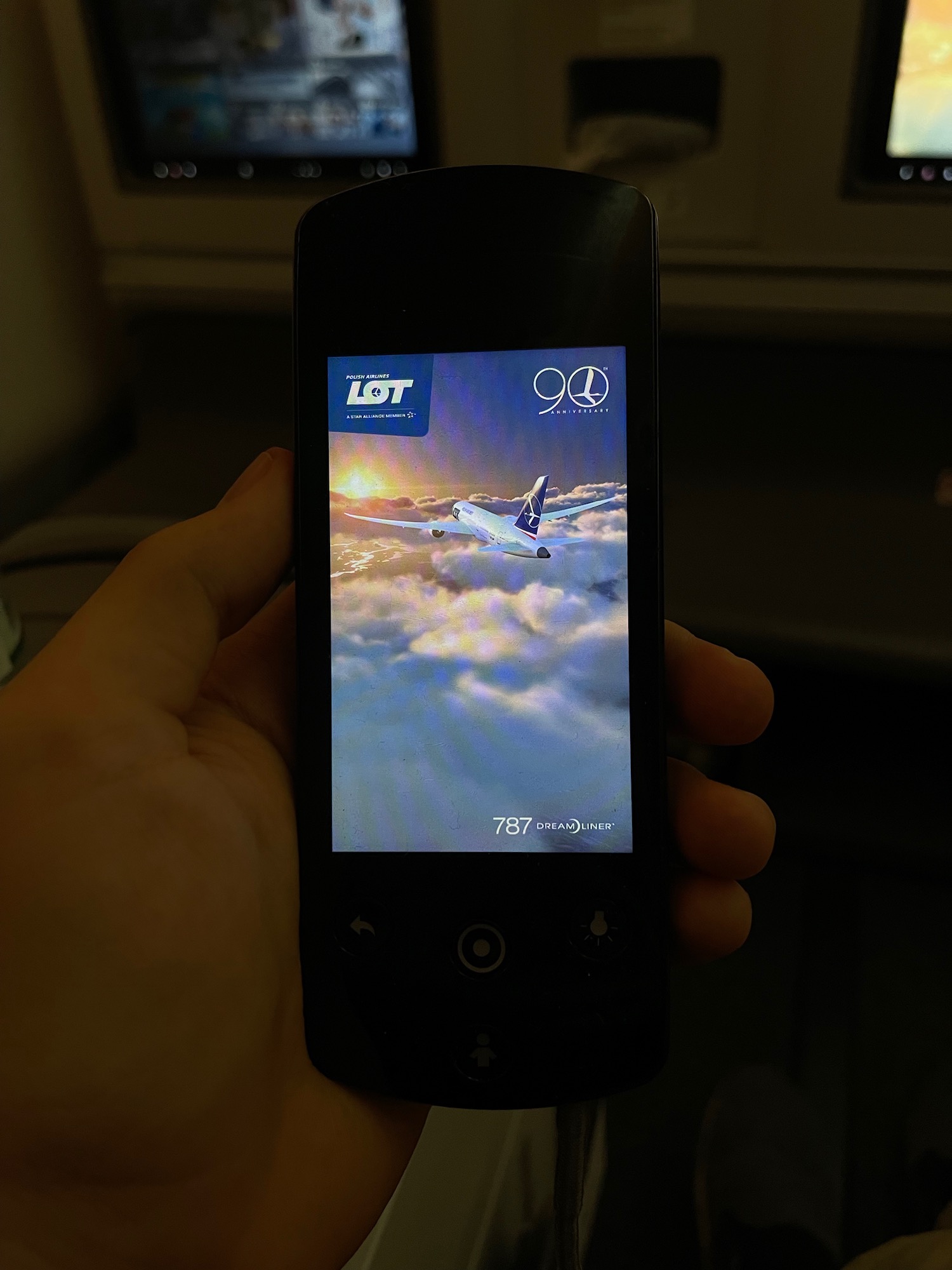 a hand holding a phone with a picture of an airplane on the screen