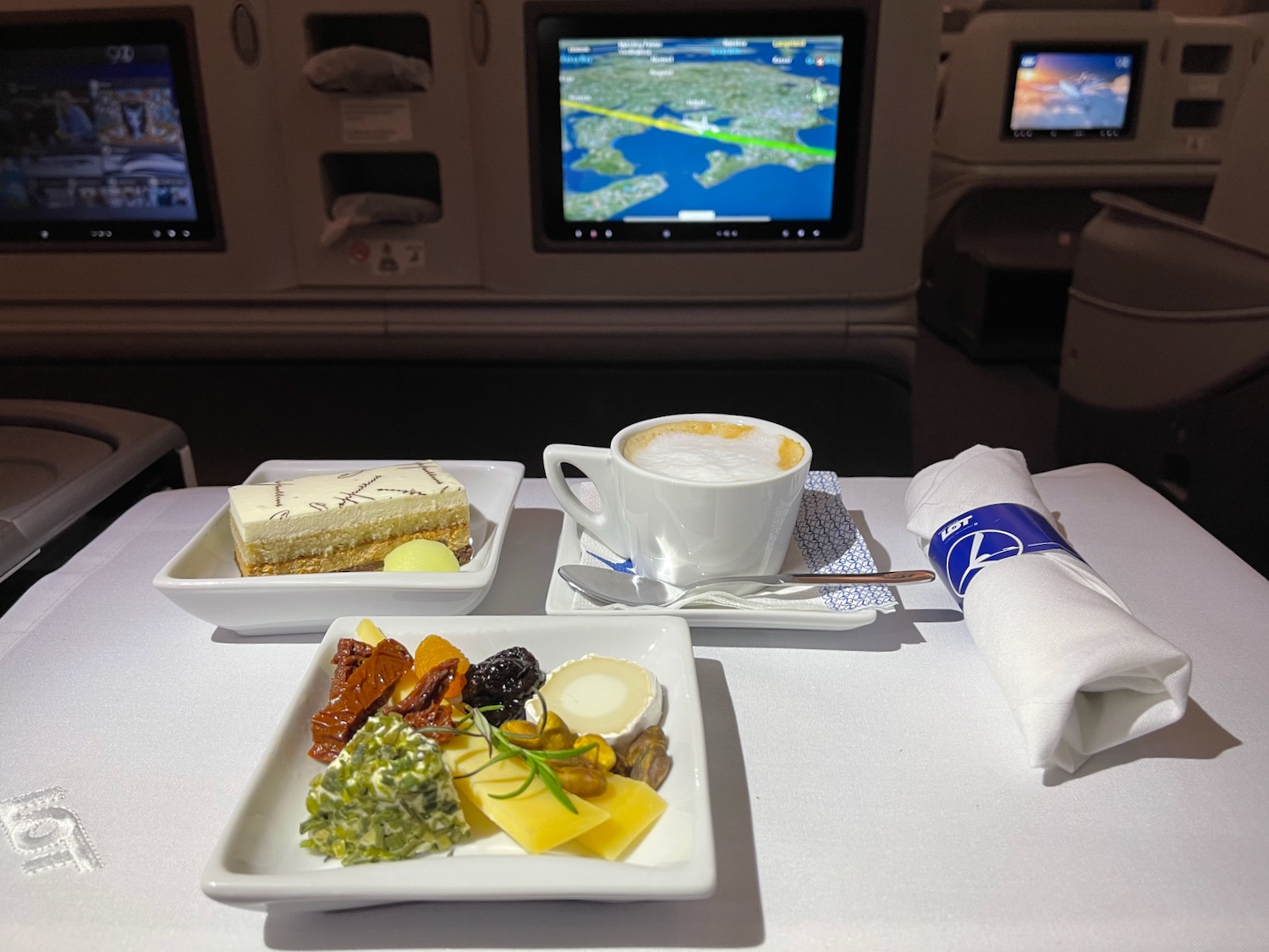 a table with plates of food and a cup of coffee on it