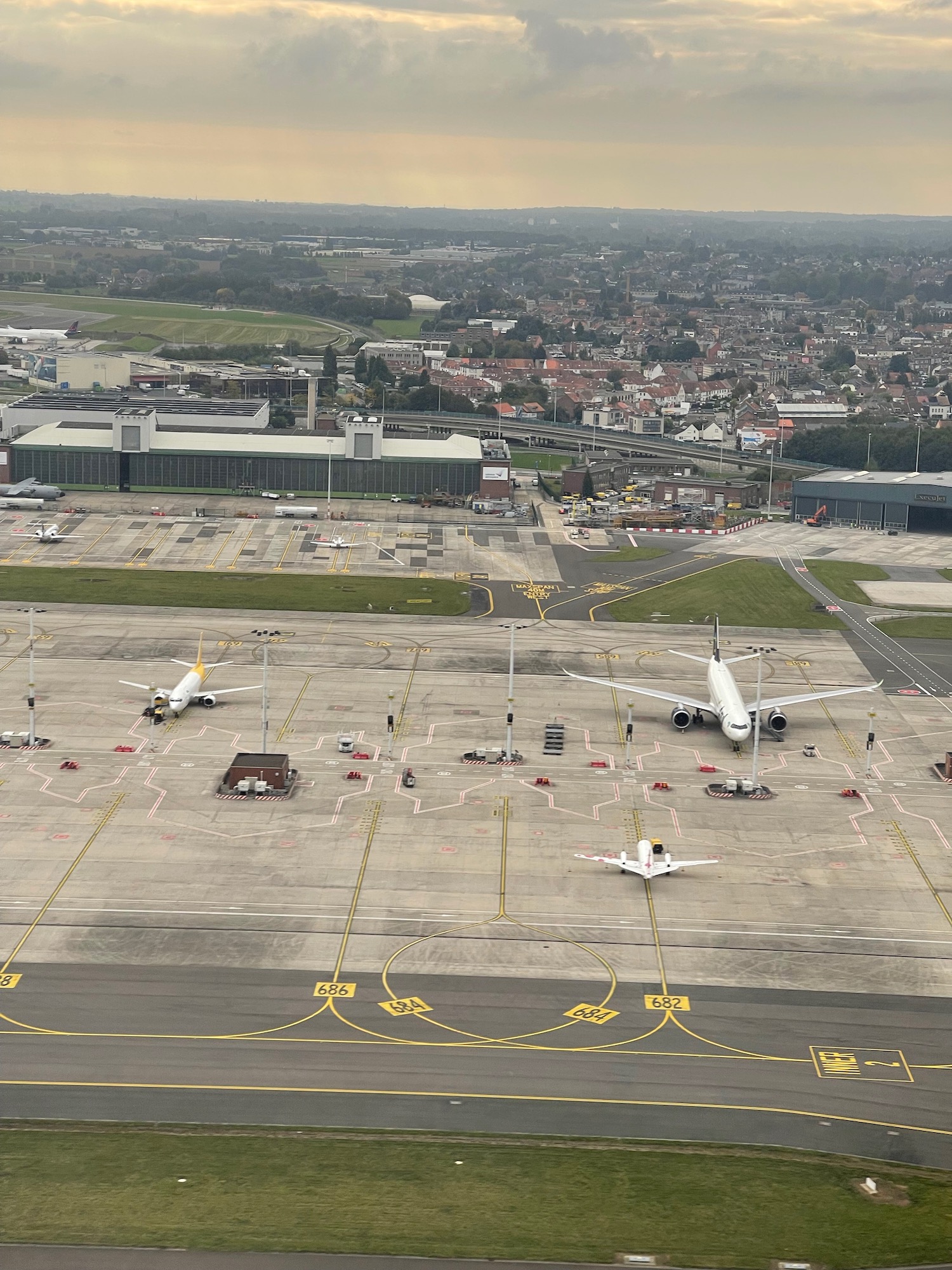 an aerial view of airplanes on a runway