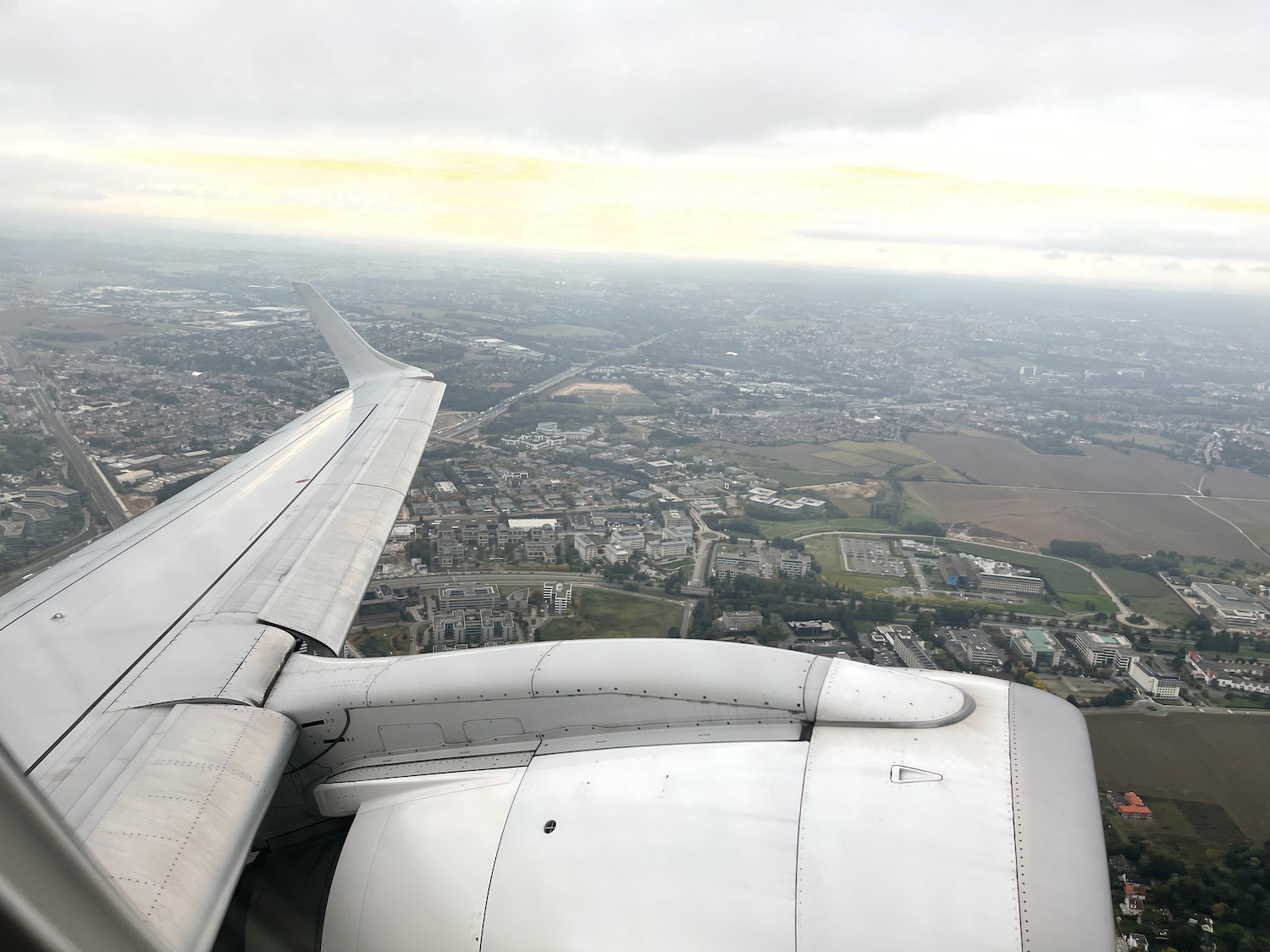 an airplane wing and a city