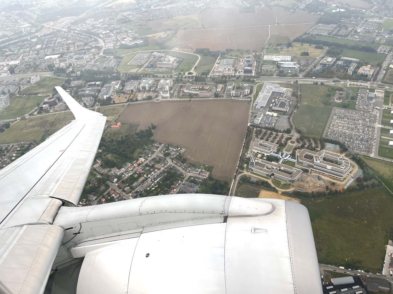 an airplane wing and a city