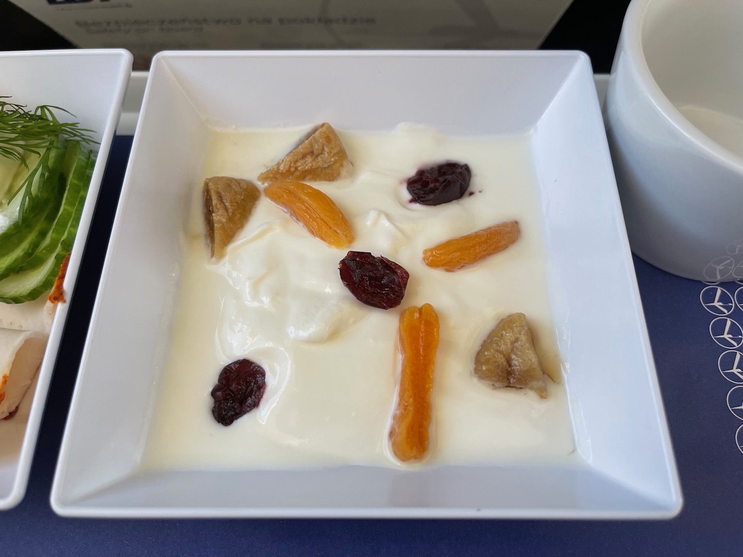 a white bowl with fruit in it