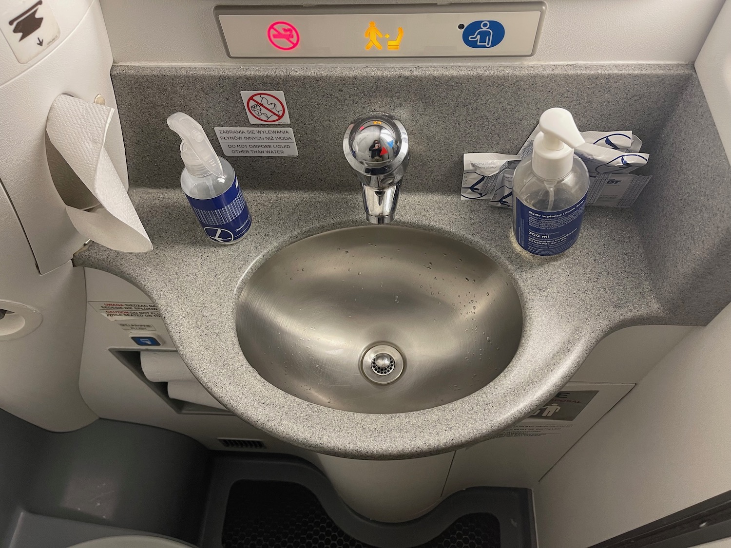 a sink with soap and hand sanitizer on it