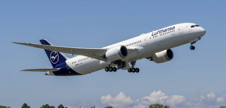 a white airplane flying in the sky