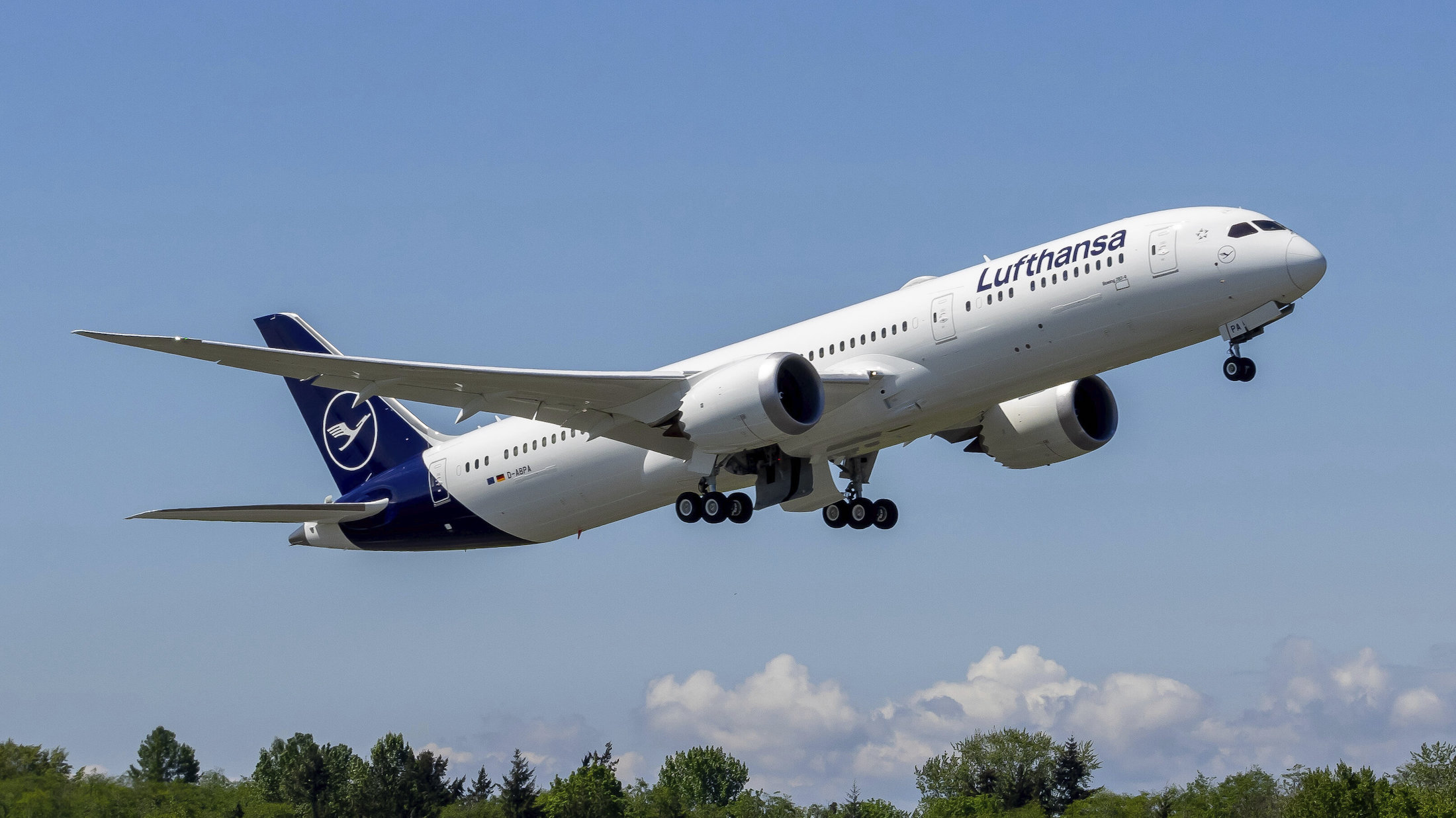 a white airplane flying in the sky