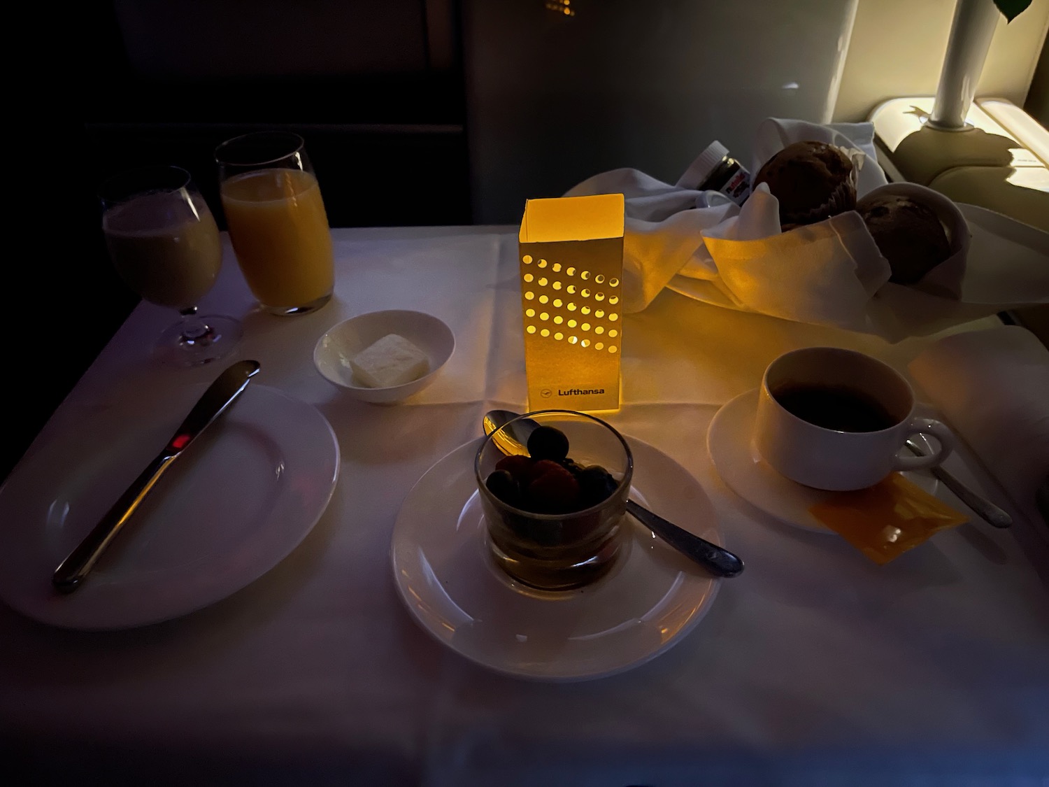 a table with plates and cups of coffee and orange juice