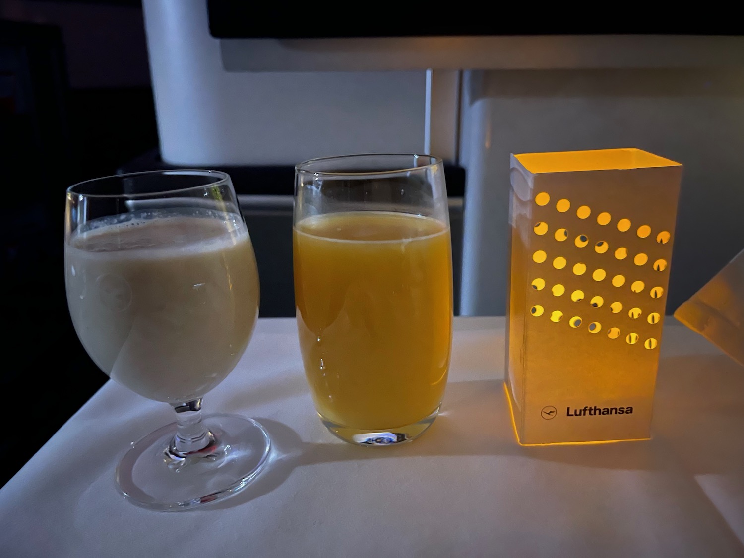 a glass of orange juice next to a box