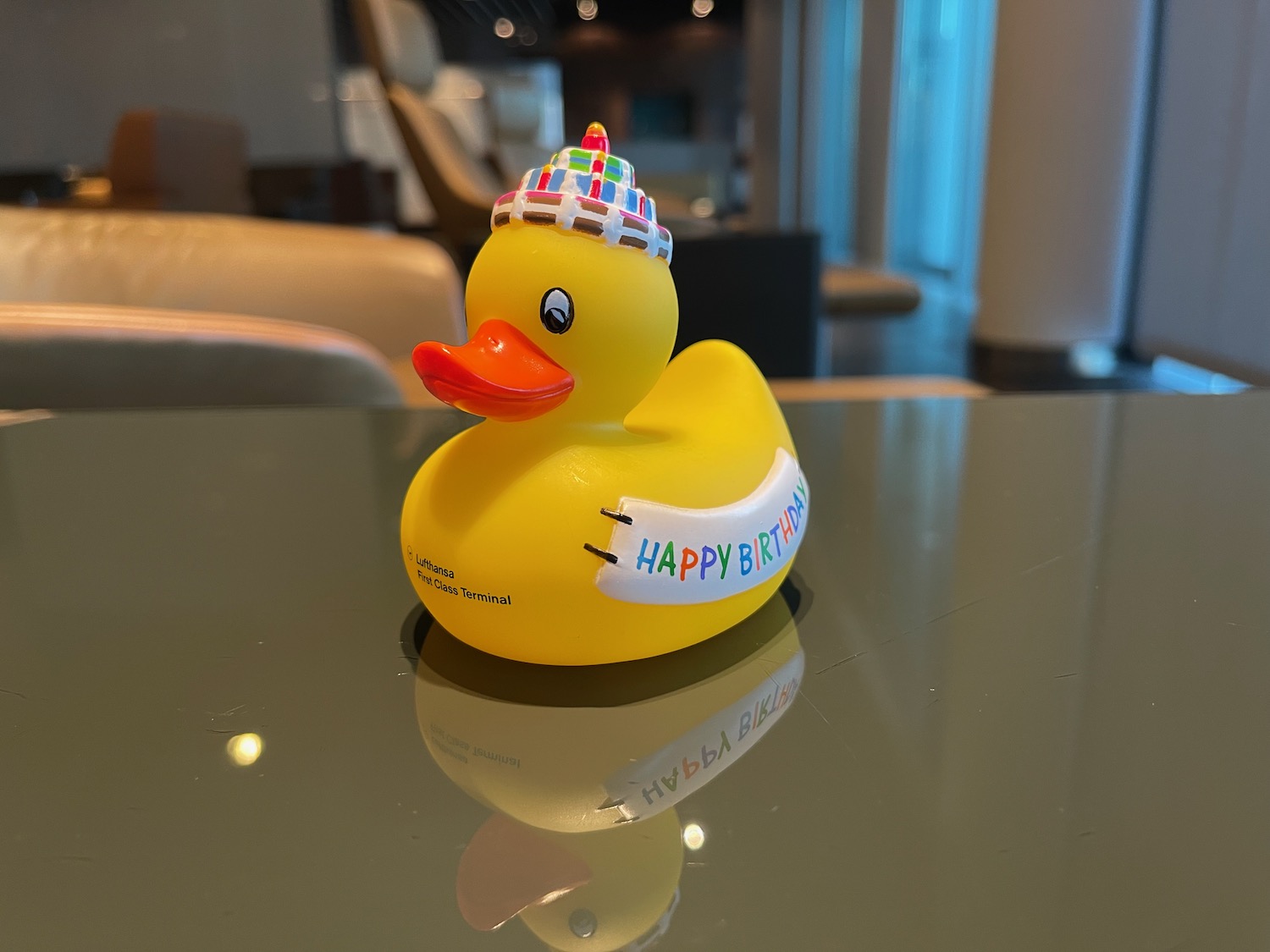 a yellow rubber duck with a hat on a table