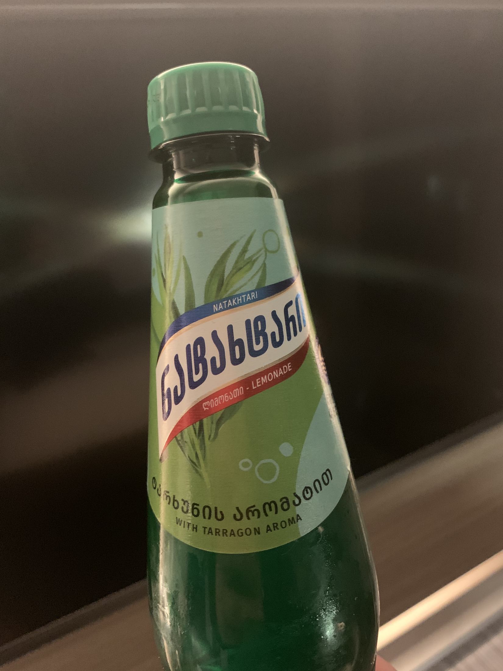 a green bottle with a label