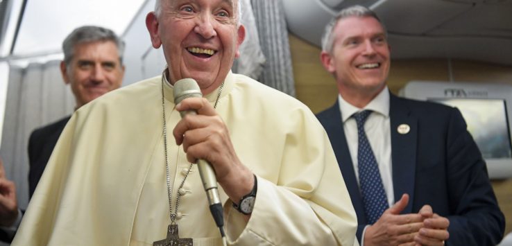 a man in a white robe holding a microphone