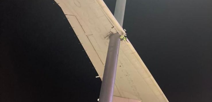 a light pole with a plane wing