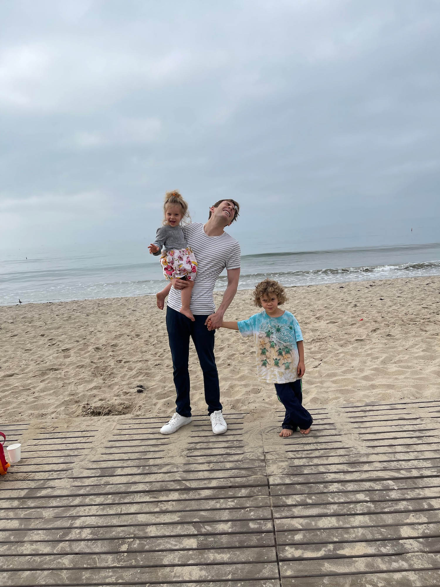 a man holding a child on a beach