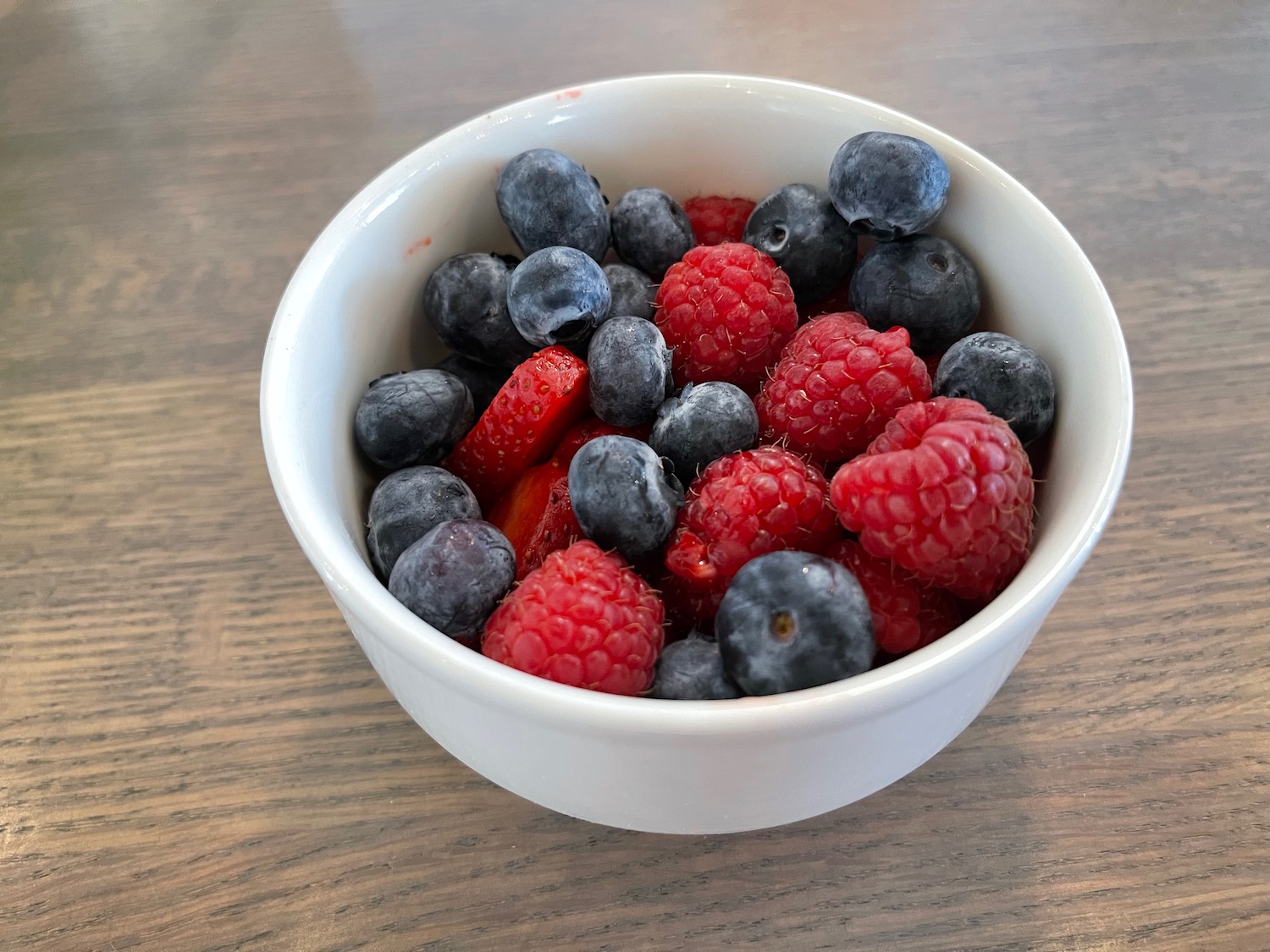 a bowl of berries on a table