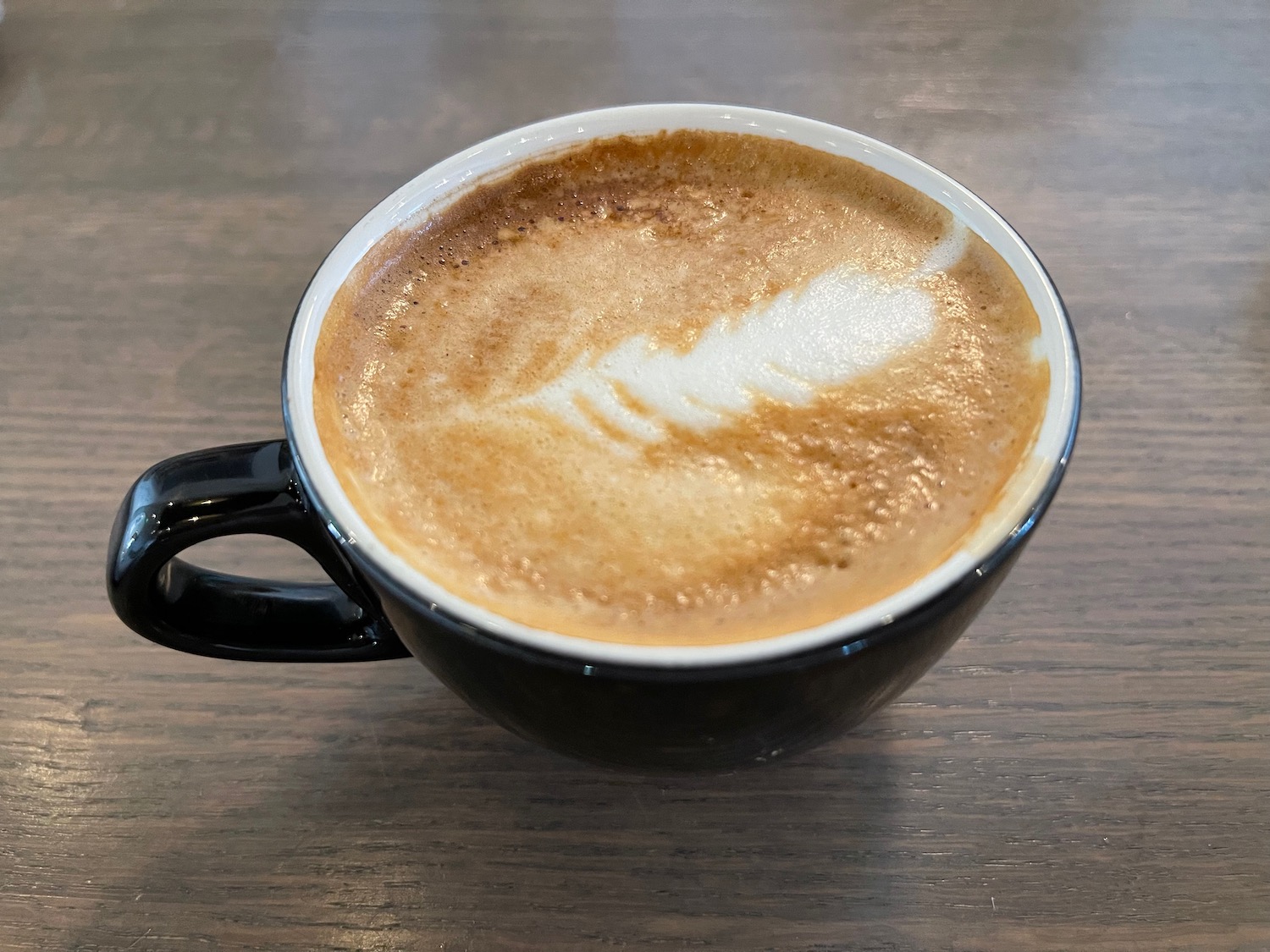 a cup of coffee with a latte art in it