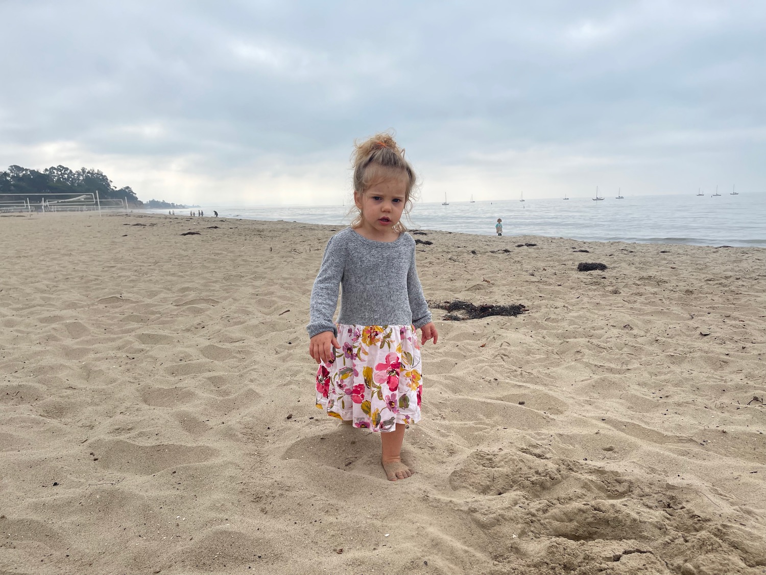 a girl standing on sand