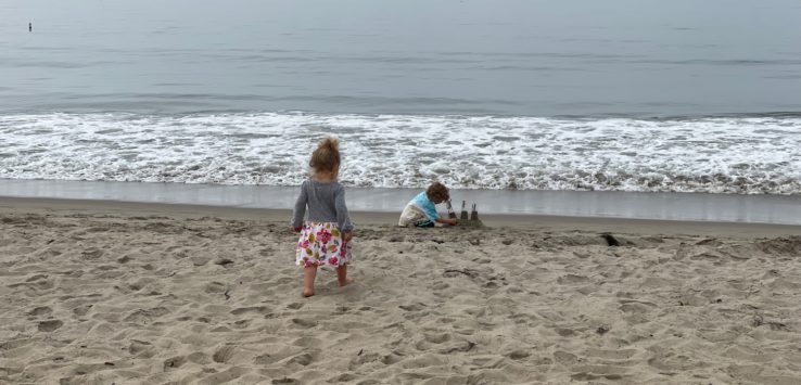 two children playing on the beach