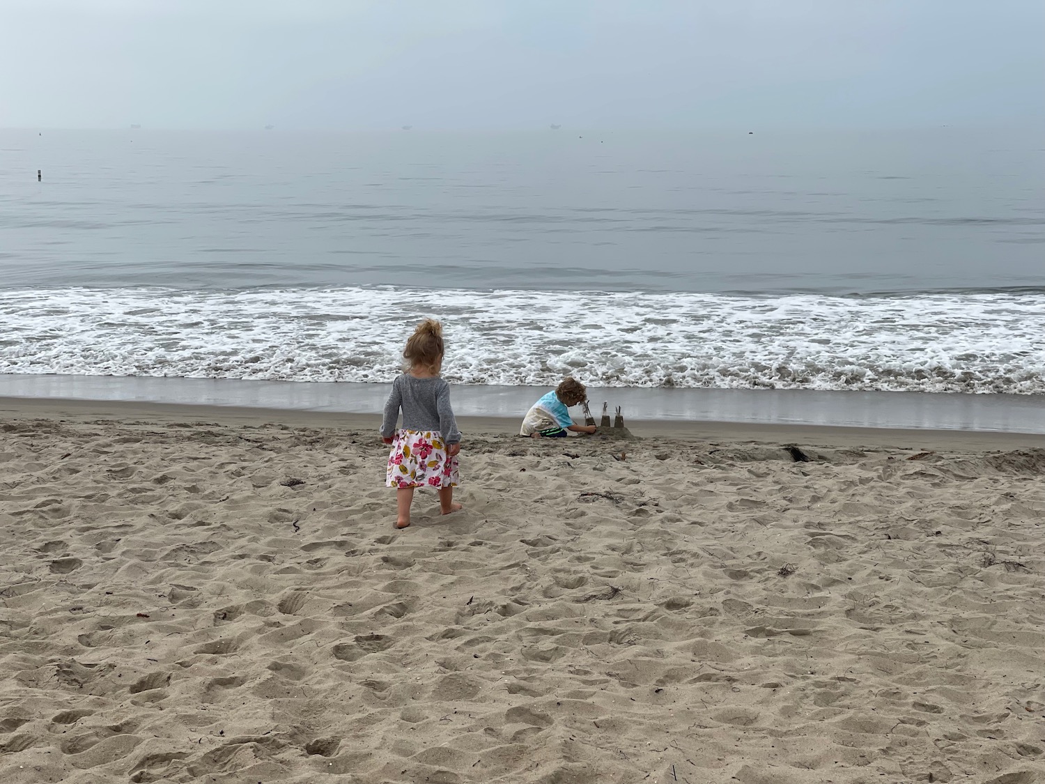 two children playing on the beach