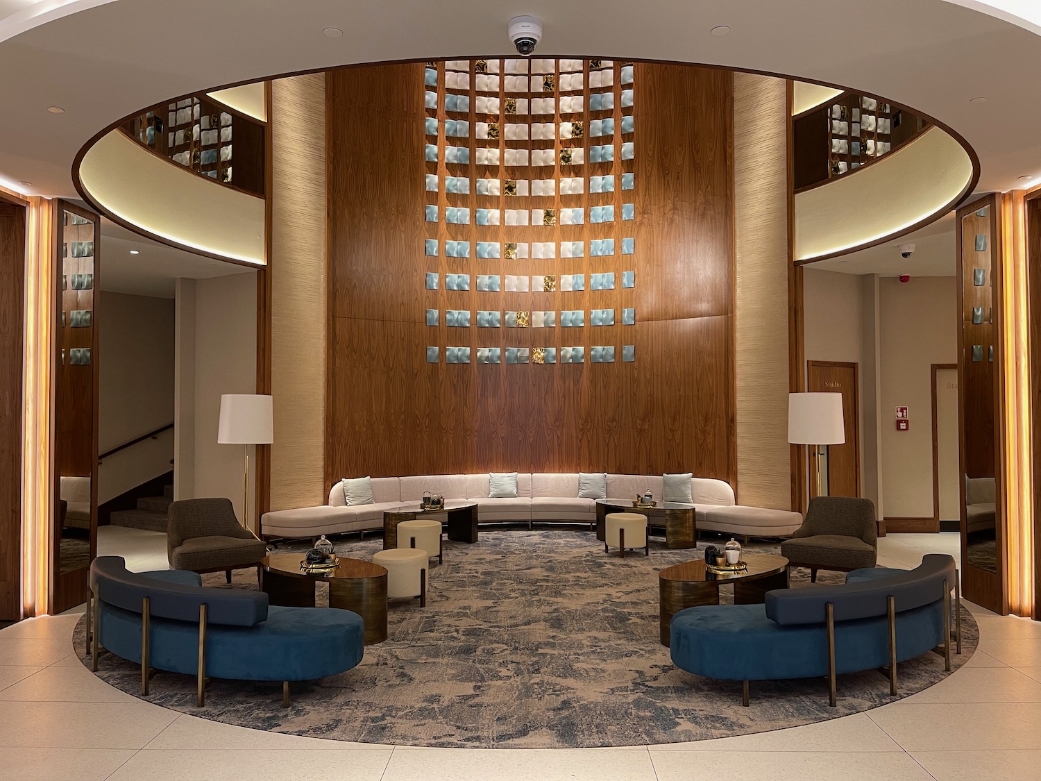 a large room with a round couch and a round table