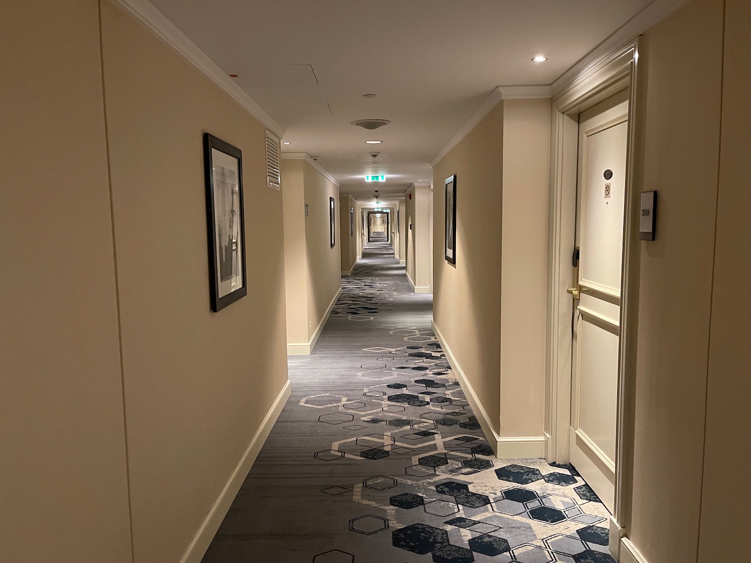 a long hallway with a carpeted floor and a door