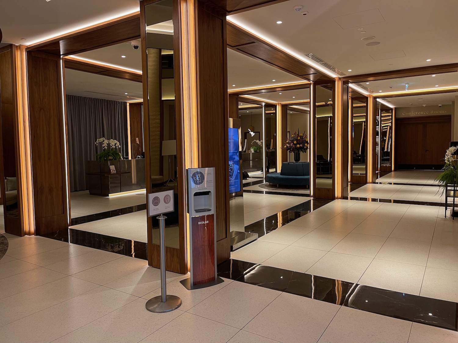 a large lobby with glass walls and a mirror