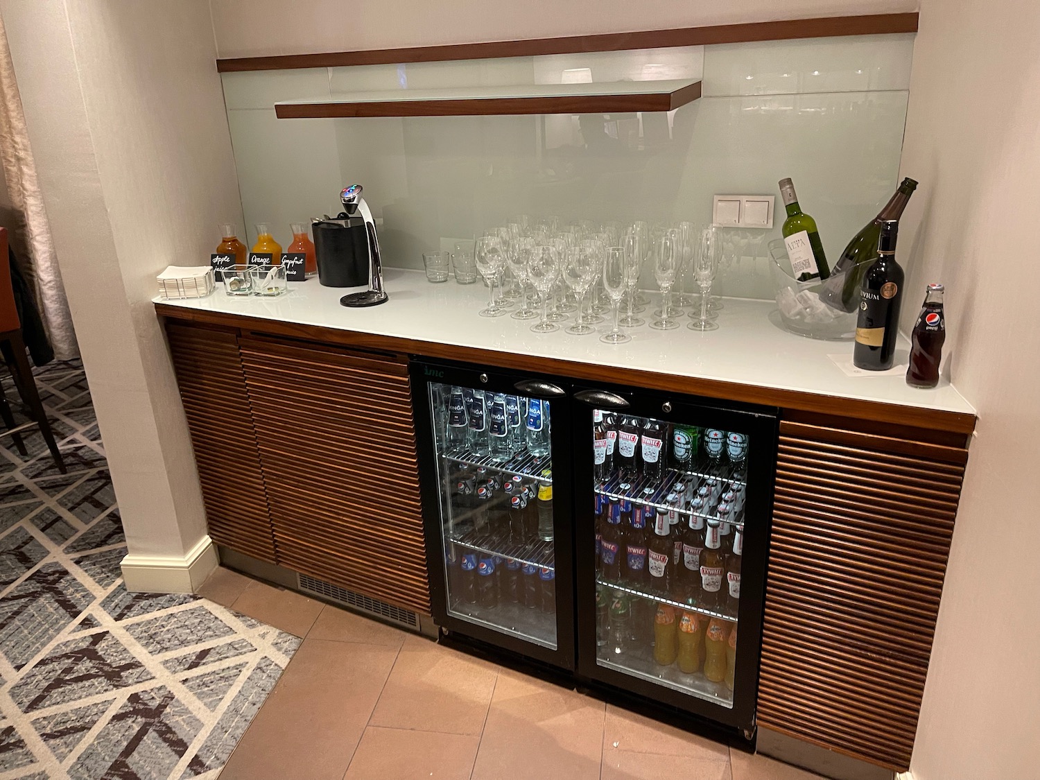 a bar with wine bottles and glasses