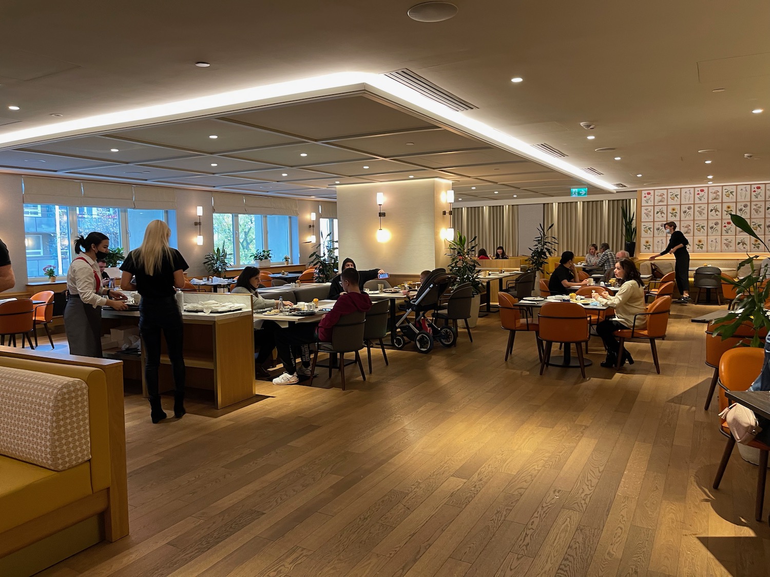 a group of people sitting at tables in a room with chairs and tables