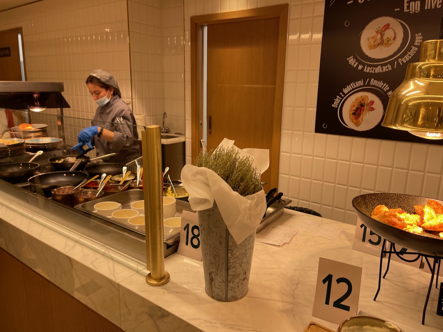 a woman cooking food in a kitchen