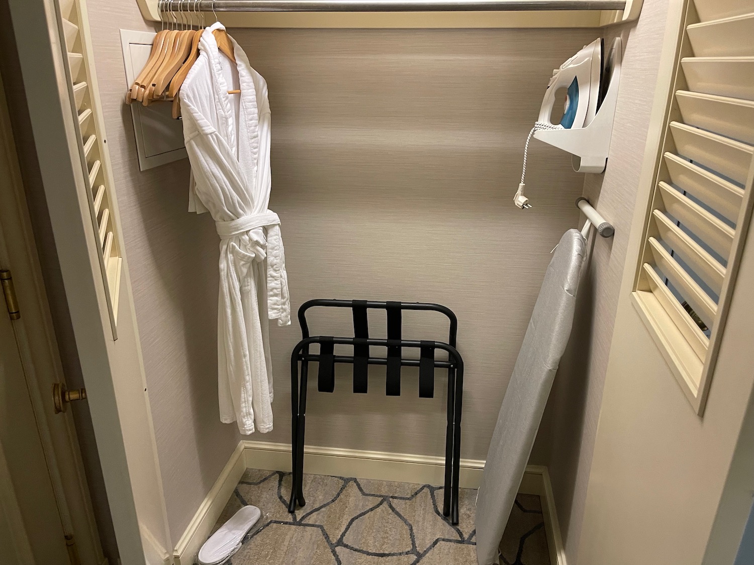 a white robe on a swinger in a closet