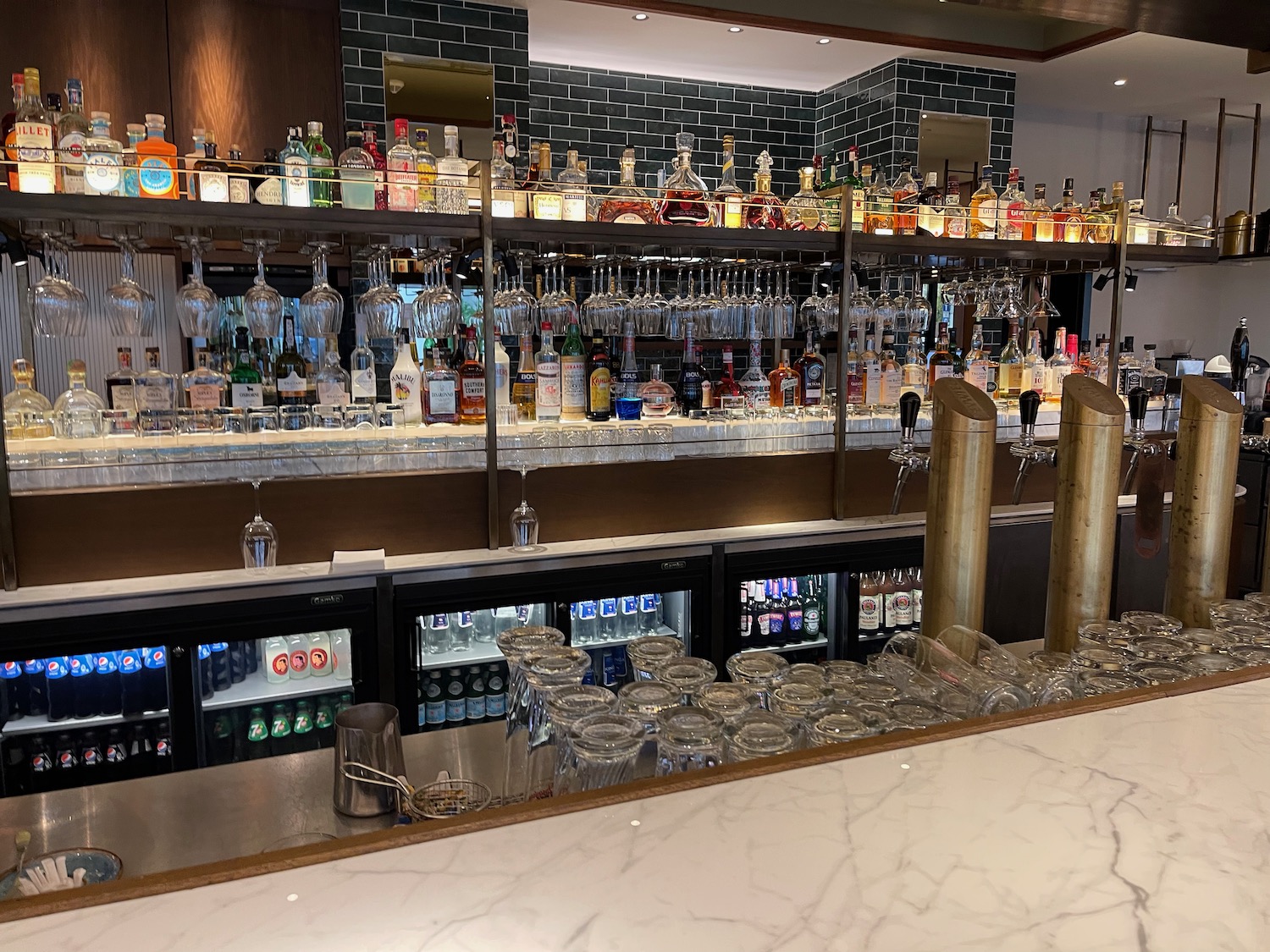 a bar with many bottles and glasses