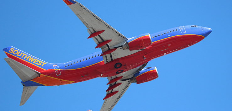 a red and blue airplane in the sky