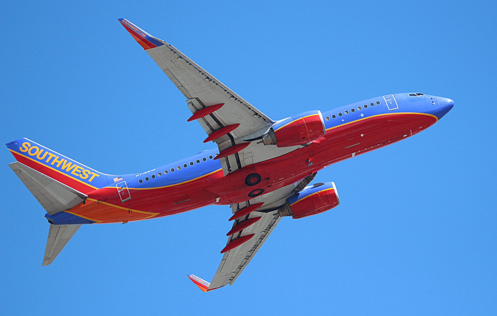 a red and blue airplane in the sky