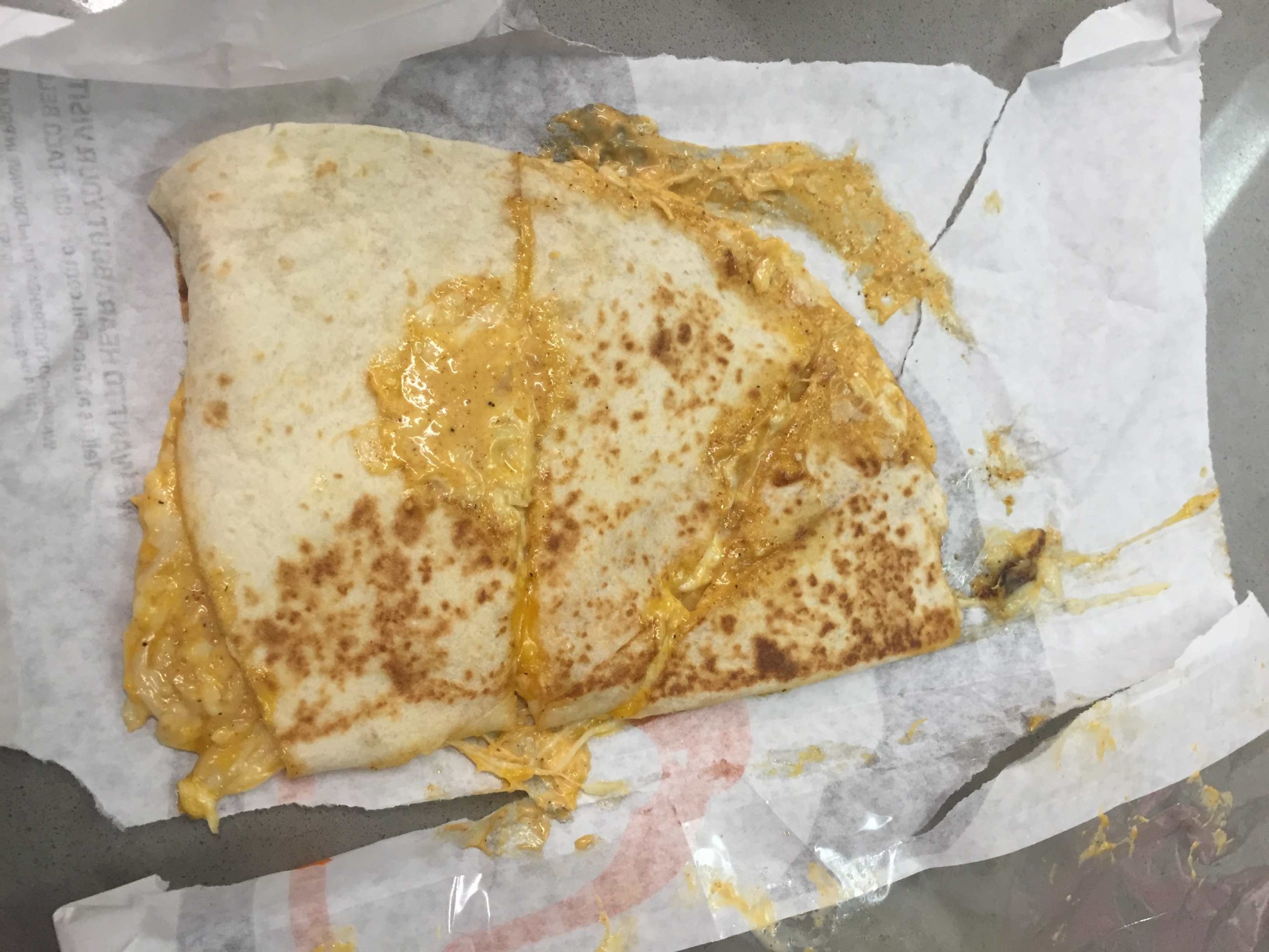 a quesadilla on a paper wrapper