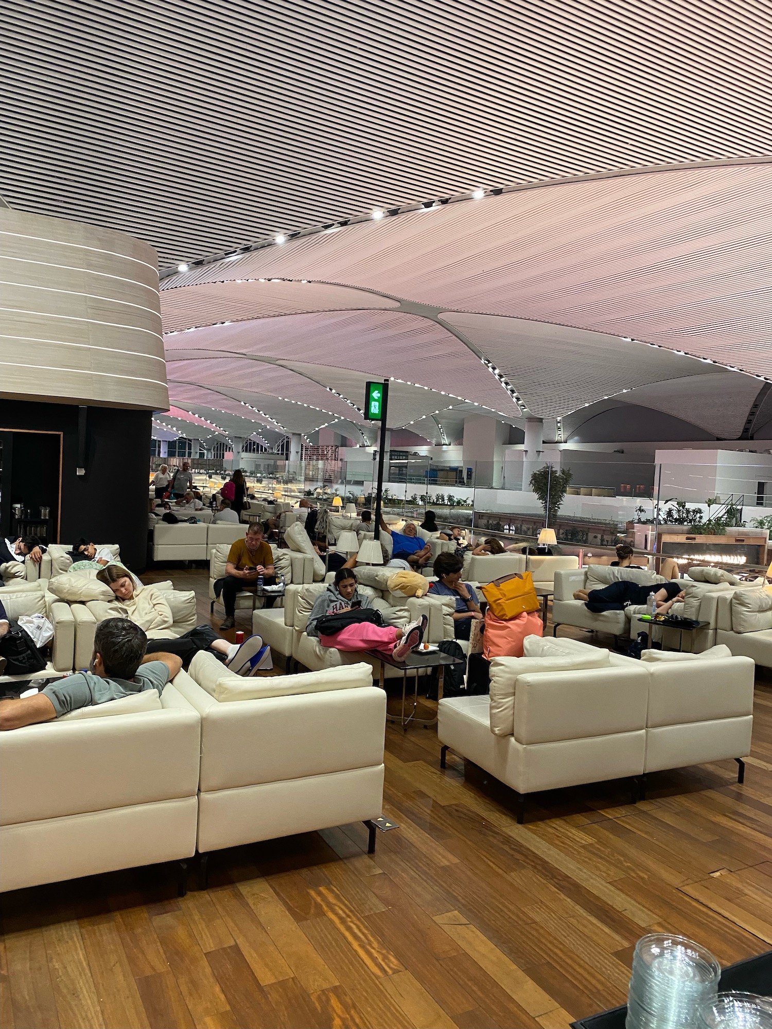 a group of people sitting in a room with white couches