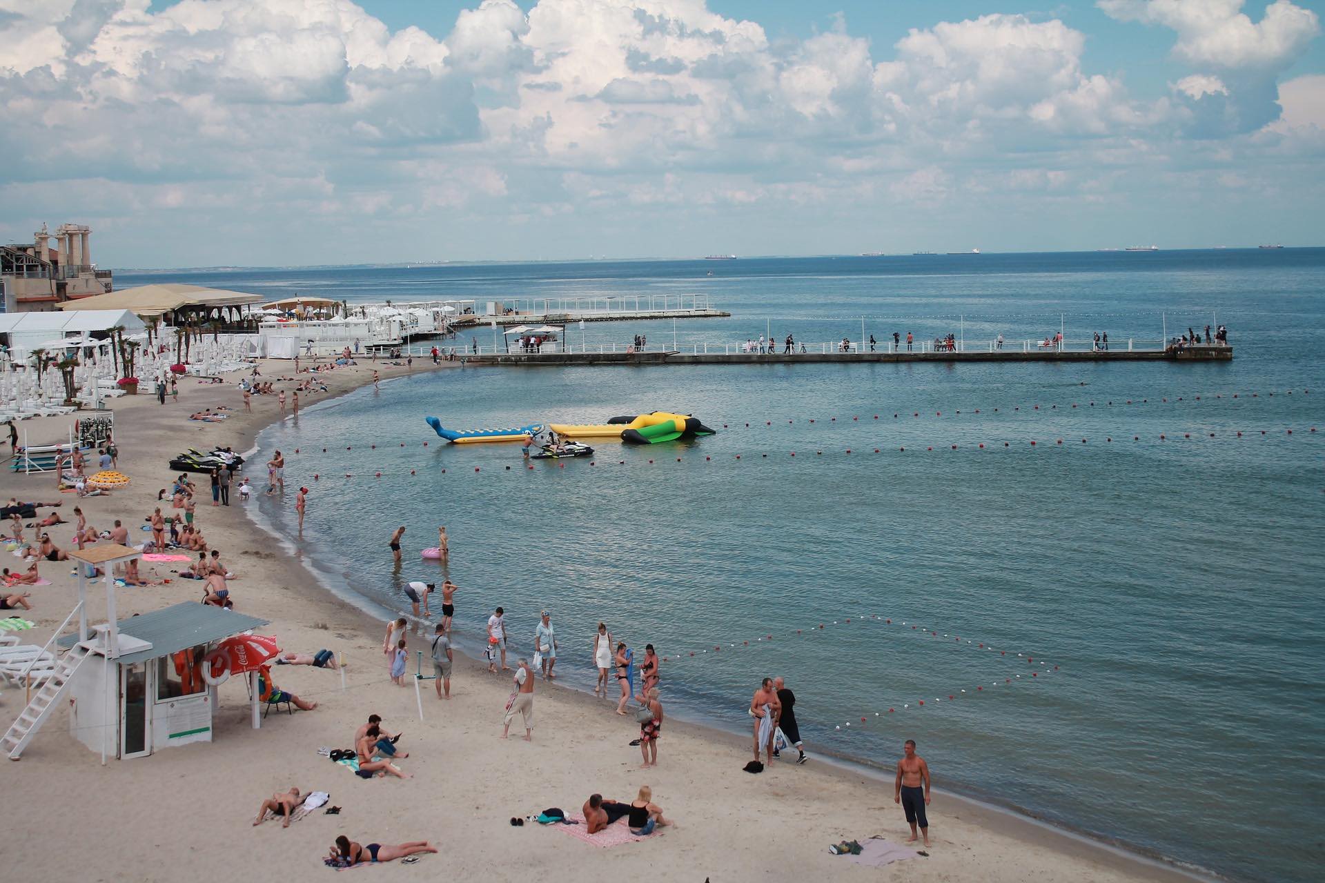 a beach with people and boats