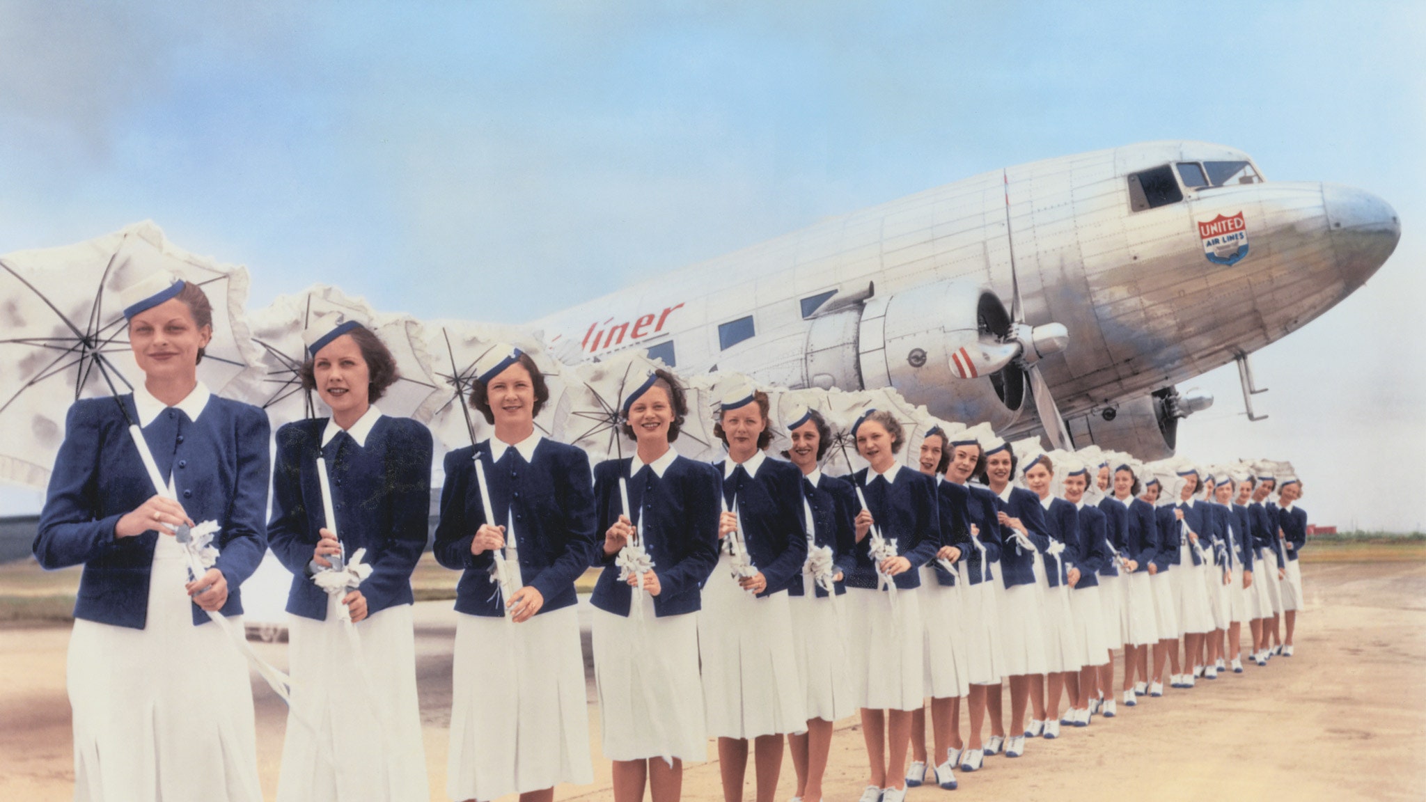 a group of women in uniform holding white objects