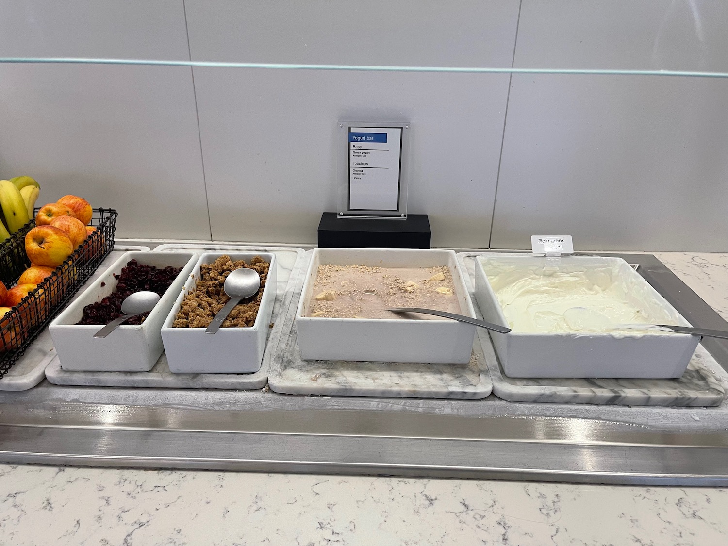 a row of bowls of cereals and yogurt