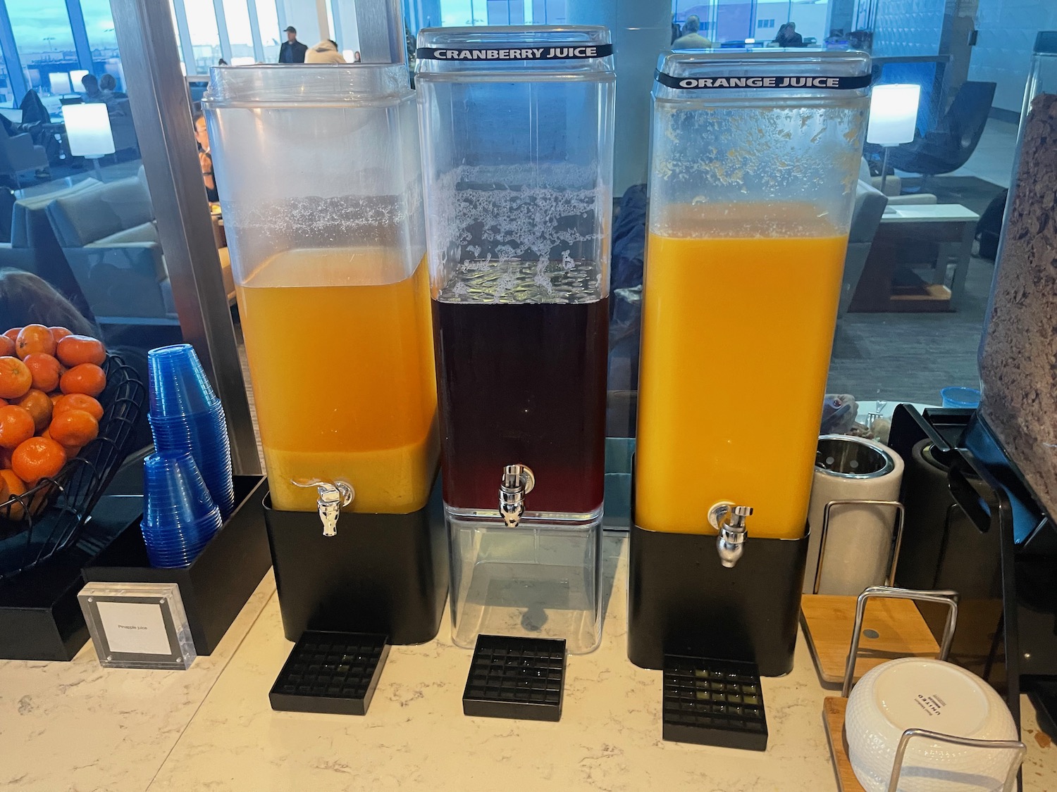 a group of juice dispensers on a table