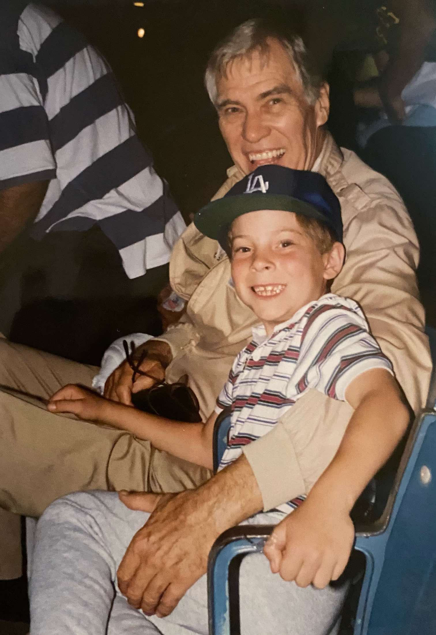 a man and boy sitting on a chair